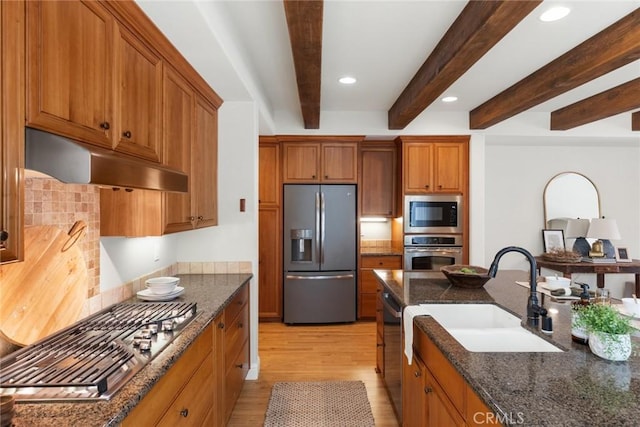 35 Veneto Cir, Chico, CA 95926 - kitchen with appliances with stainless steel finishes, under cabinet range hood, a sink, brown cabinets, and beamed ceiling