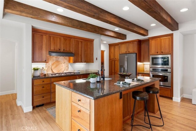 35 Veneto Cir, Chico, CA 95926 - kitchen with appliances with stainless steel finishes, a sink, baseboards, under cabinet range hood, and light wood-style flooring