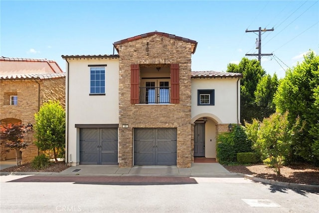 35 Veneto Cir, Chico, CA 95926 - mediterranean / spanish house with stucco siding, an attached garage, a balcony, stone siding, and driveway