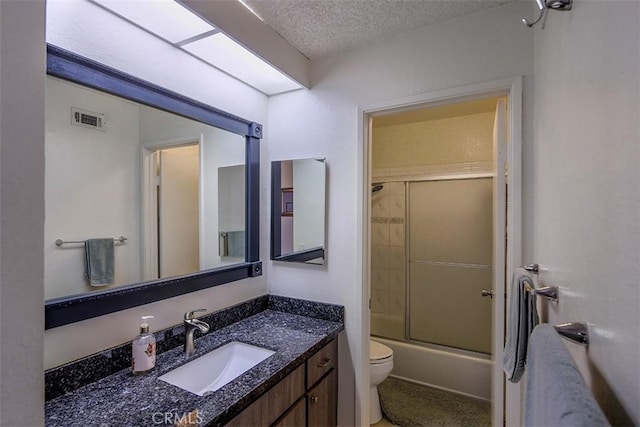821 S Cerritos Ave Unit 17, Azusa, CA 91702 - full bathroom with toilet, vanity, combined bath / shower with glass door, and a textured ceiling