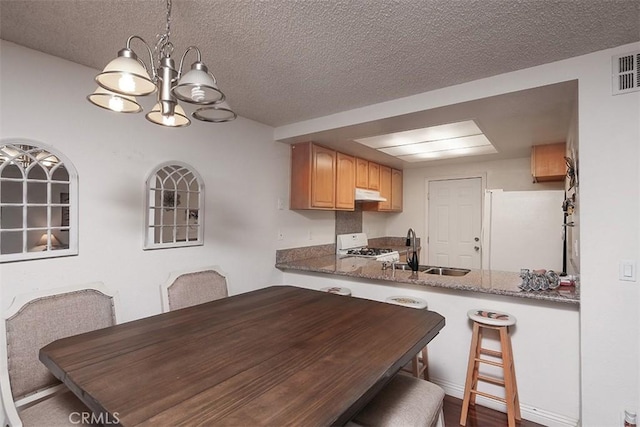 821 S Cerritos Ave Unit 17, Azusa, CA 91702 - dining room featuring a chandelier and a textured ceiling