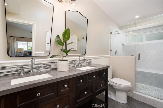 292 Bowling Green Dr, Costa Mesa, CA 92626 - bathroom with double vanity, a marble finish shower, wainscoting, and vaulted ceiling