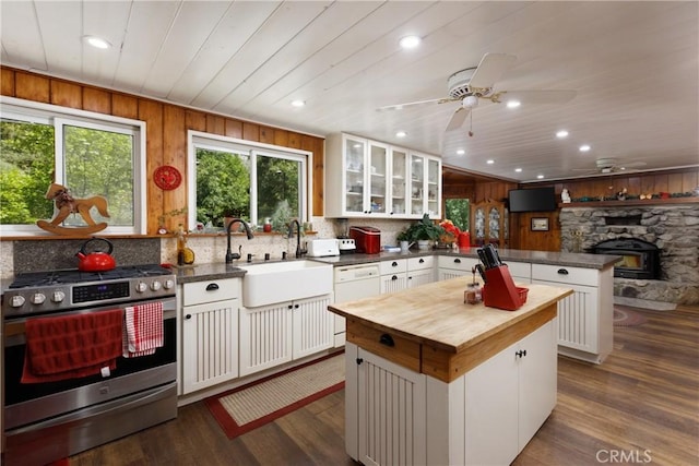 9091 Mountain View Dr, Forest Falls, CA 92339 - kitchen with stainless steel gas range, butcher block countertops, white dishwasher, a peninsula, and a sink