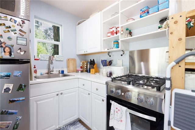 9091 Mountain View Dr, Forest Falls, CA 92339 - kitchen with stainless steel appliances, a sink, white cabinets, and light countertops