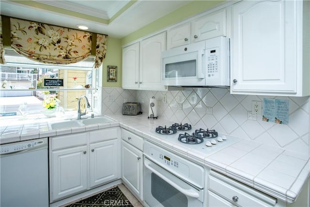 11 Jasmine Creek Ln, Laguna Hills, CA 92653 - kitchen featuring white appliances, tile counters, a sink, ornamental molding, and white cabinetry