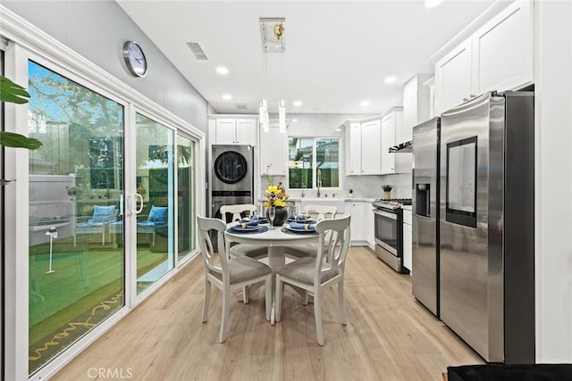 6149 Rosemead Blvd, Temple City, CA 91780 - kitchen featuring stainless steel appliances, stacked washing machine and dryer, light wood-style floors, white cabinetry, and recessed lighting