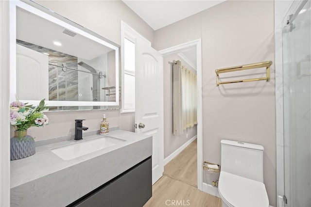 6149 Rosemead Blvd, Temple City, CA 91780 - full bathroom featuring vanity, a stall shower, toilet, wood finished floors, and baseboards