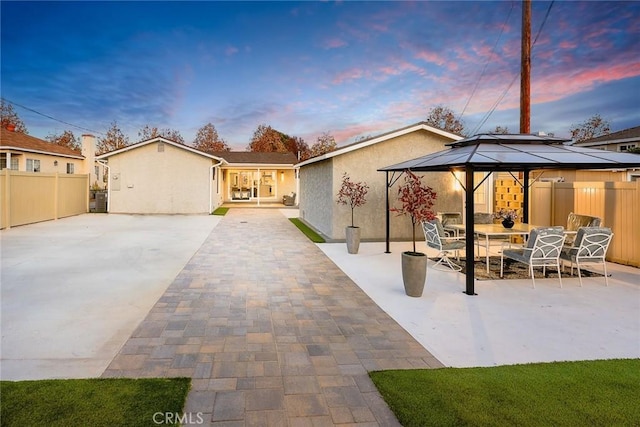 6149 Rosemead Blvd, Temple City, CA 91780 - back of house at dusk with a gazebo, stucco siding, a patio area, and outdoor dining area