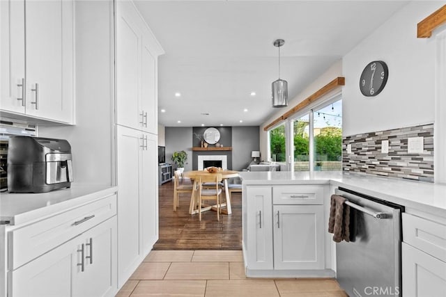 18534 Dylan St, Porter Ranch, CA 91326 - kitchen with dishwasher, white cabinets, open floor plan, decorative backsplash, and light countertops