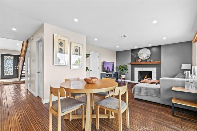 18534 Dylan St, Porter Ranch, CA 91326 - dining space with wood finished floors, a tiled fireplace, baseboards, and recessed lighting