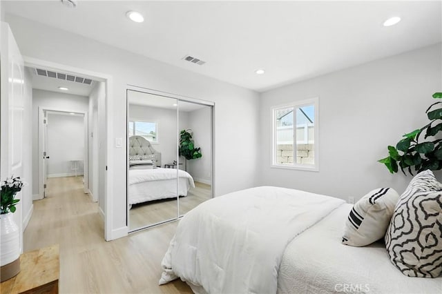 12632 Halcourt Ave, Norwalk, CA 90650 - bedroom with light wood-type flooring, multiple windows, a closet, recessed lighting, and baseboards