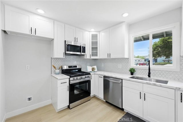 12632 Halcourt Ave, Norwalk, CA 90650 - kitchen featuring stainless steel appliances, a sink, light wood finished floors, white cabinets, and recessed lighting