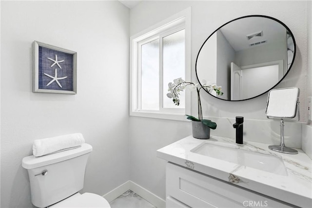 12632 Halcourt Ave, Norwalk, CA 90650 - bathroom with marble look tile flooring, toilet, vanity, and baseboards