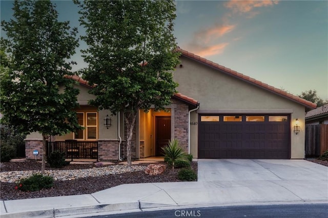 8640 Erika Ct, Atascadero, CA 93422 - view of front of property featuring stucco siding, covered porch, concrete driveway, an attached garage, and stone siding