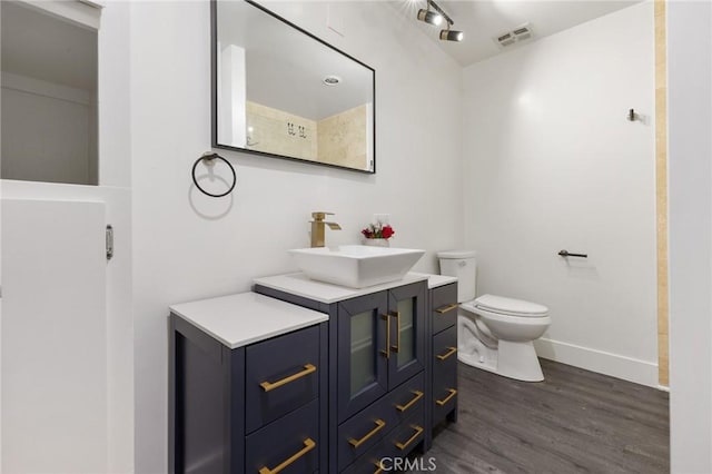 1222 N Olive Dr Unit 409, West Hollywood, CA 90069 - full bathroom featuring wood finished floors, toilet, vanity, and baseboards