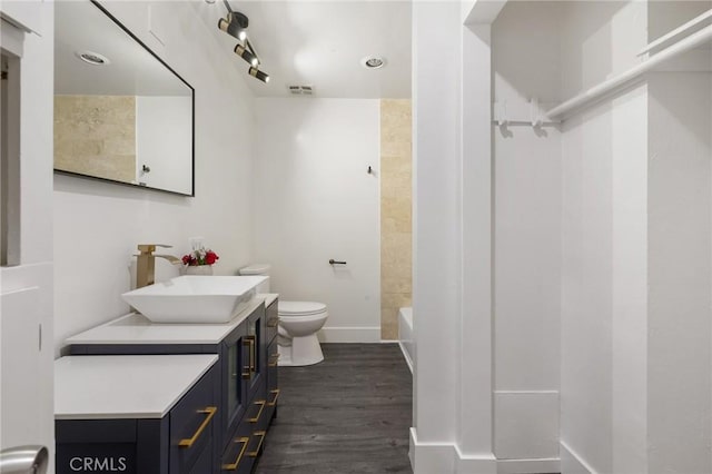 1222 N Olive Dr Unit 409, West Hollywood, CA 90069 - bathroom with toilet, vanity, wood finished floors, baseboards, and  shower combination