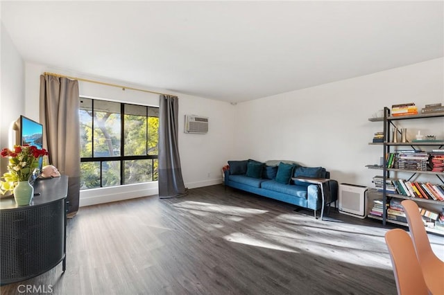 1222 N Olive Dr Unit 409, West Hollywood, CA 90069 - living room with wood finished floors, baseboards, and an AC wall unit
