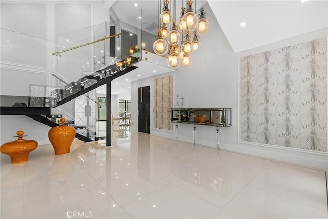 2223 Flintridge Dr, Glendale, CA 91206 - unfurnished living room with high vaulted ceiling, tile patterned floors, stairway, and a chandelier