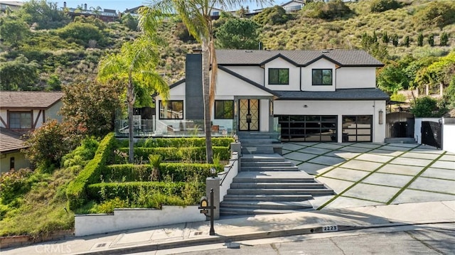 2223 Flintridge Dr, Glendale, CA 91206 - view of front of house with stucco siding, driveway, and a garage