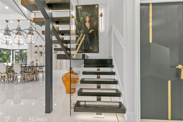 2223 Flintridge Dr, Glendale, CA 91206 - stairs with a decorative wall and a chandelier