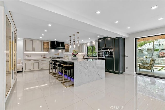 2223 Flintridge Dr, Glendale, CA 91206 - kitchen featuring ventilation hood, light tile patterned flooring, a spacious island, light stone countertops, and a breakfast bar area