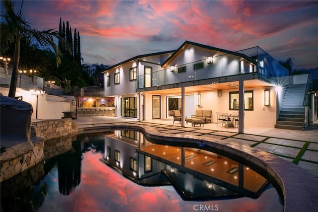 2223 Flintridge Dr, Glendale, CA 91206 - back of property with a balcony, a patio, stucco siding, and stairway