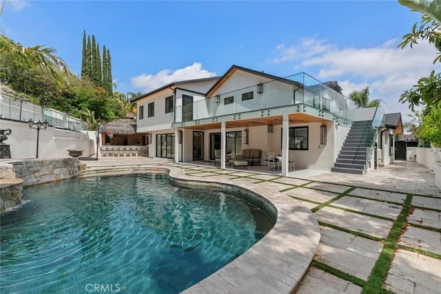 2223 Flintridge Dr, Glendale, CA 91206 - back of house featuring stucco siding, stairs, a patio, an outdoor hangout area, and a balcony