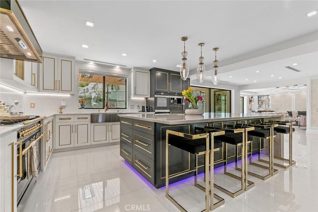 2223 Flintridge Dr, Glendale, CA 91206 - kitchen featuring range hood, range with gas cooktop, gray cabinets, a large island, and recessed lighting