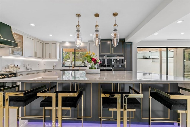 2223 Flintridge Dr, Glendale, CA 91206 - kitchen with recessed lighting, light stone countertops, a sink, decorative light fixtures, and a large island