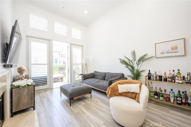 2233 Martin Unit 411, Irvine, CA 92612 - living room with light wood finished floors, a towering ceiling, and recessed lighting