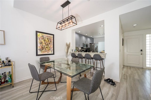 2233 Martin Unit 411, Irvine, CA 92612 - dining space featuring light wood-type flooring, baseboards, a chandelier, and recessed lighting