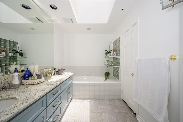 2233 Martin Unit 411, Irvine, CA 92612 - full bathroom featuring a garden tub, double vanity, a skylight, and tile patterned floors