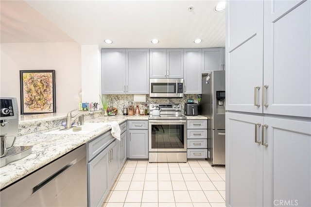 2233 Martin Unit 411, Irvine, CA 92612 - kitchen featuring appliances with stainless steel finishes, gray cabinetry, a sink, light tile patterned floors, and recessed lighting