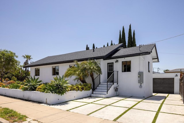 1958 Edgemont St, San Diego, CA 92102 - view of front facade featuring a shingled roof, stucco siding, and a garage