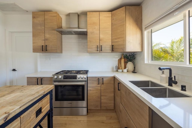 1958 Edgemont St, San Diego, CA 92102 - kitchen with stainless steel range with gas stovetop, wall chimney exhaust hood, a sink, and tasteful backsplash