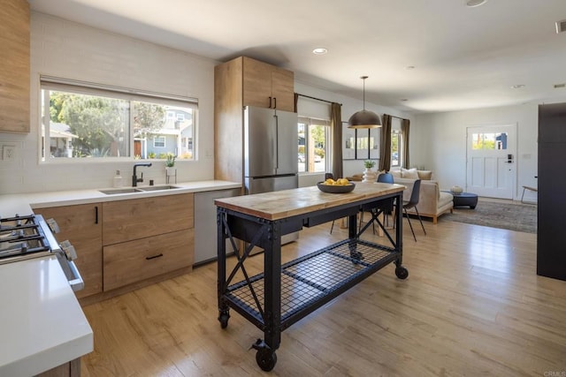 1958 Edgemont St, San Diego, CA 92102 - kitchen with a sink, light wood-style floors, light countertops, appliances with stainless steel finishes, and recessed lighting