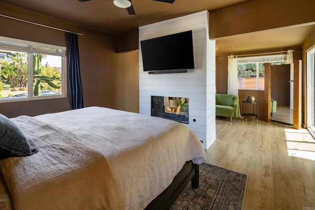 1958 Edgemont St, San Diego, CA 92102 - bedroom featuring wood finished floors, a multi sided fireplace, and ceiling fan