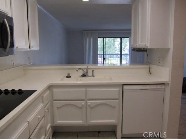 13601 Del Monte Dr Unit M17-46A, Seal Beach, CA 90740 - kitchen with dishwasher, a sink, stainless steel microwave, white cabinets, and tile patterned floors
