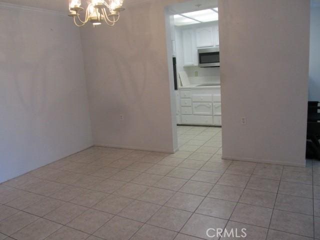13601 Del Monte Dr Unit M17-46A, Seal Beach, CA 90740 - empty room with a chandelier, crown molding, and light tile patterned floors