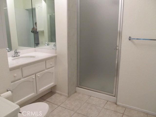 13601 Del Monte Dr Unit M17-46A, Seal Beach, CA 90740 - bathroom with vanity, a stall shower, tile patterned flooring, toilet, and baseboards