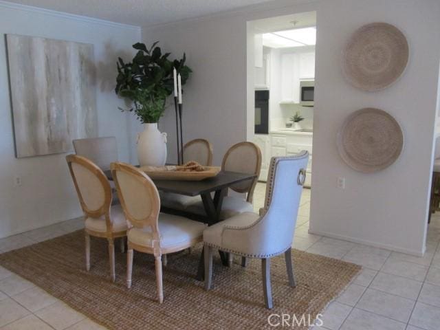 13601 Del Monte Dr Unit M17-46A, Seal Beach, CA 90740 - dining area with light tile patterned floors, crown molding, and baseboards