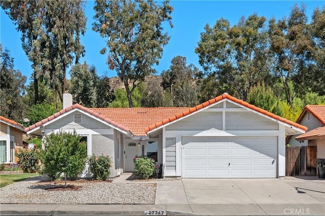 27747 Wakefield Rd, Castaic, CA 91384 - view of front of home with a tile roof, a chimney, concrete driveway, and stucco siding