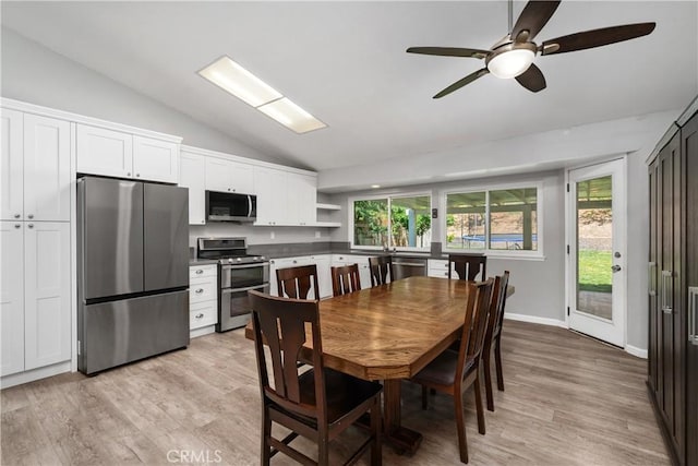 27747 Wakefield Rd, Castaic, CA 91384 - dining area featuring lofted ceiling, light wood-type flooring, and a ceiling fan