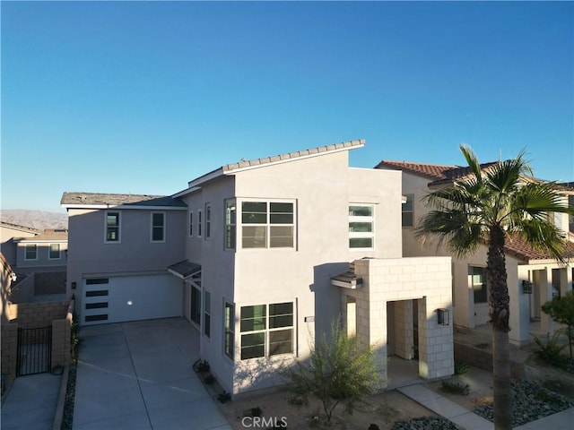 35806 Mccarthy St, Palm Desert, CA 92211 - view of front facade featuring stucco siding, a garage, and concrete driveway