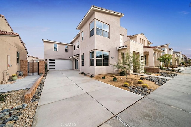 35806 Mccarthy St, Palm Desert, CA 92211 - view of front of house featuring a garage, stucco siding, a gate, and driveway
