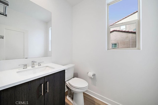 35806 Mccarthy St, Palm Desert, CA 92211 - half bathroom with vanity, toilet, wood finished floors, and baseboards