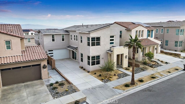 35806 Mccarthy St, Palm Desert, CA 92211 - view of front facade with an attached garage, driveway, a residential view, and stucco siding