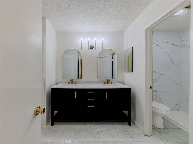23947 Del Monte Dr Unit 5, Valencia, CA 91355 - bathroom featuring marble look tile flooring, double vanity, toilet, a marble finish shower, and baseboards
