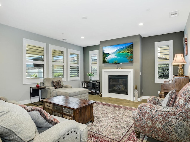 374 Ventasso Way, Fallbrook, CA 92028 - living area featuring a glass covered fireplace, baseboards, recessed lighting, and wood finished floors