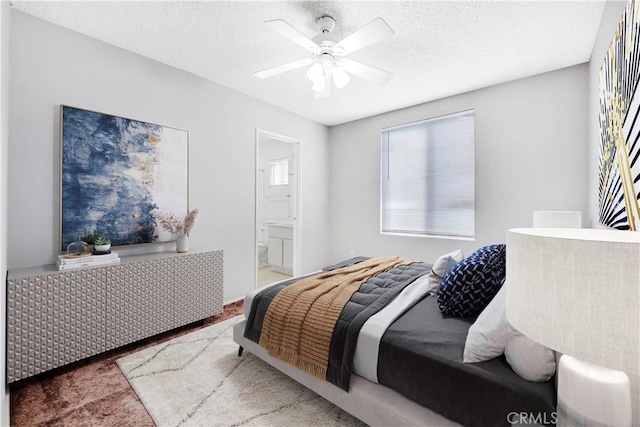 37940 42nd St E Unit 125, Palmdale, CA 93552 - bedroom with a textured ceiling, carpet floors, ensuite bath, and ceiling fan